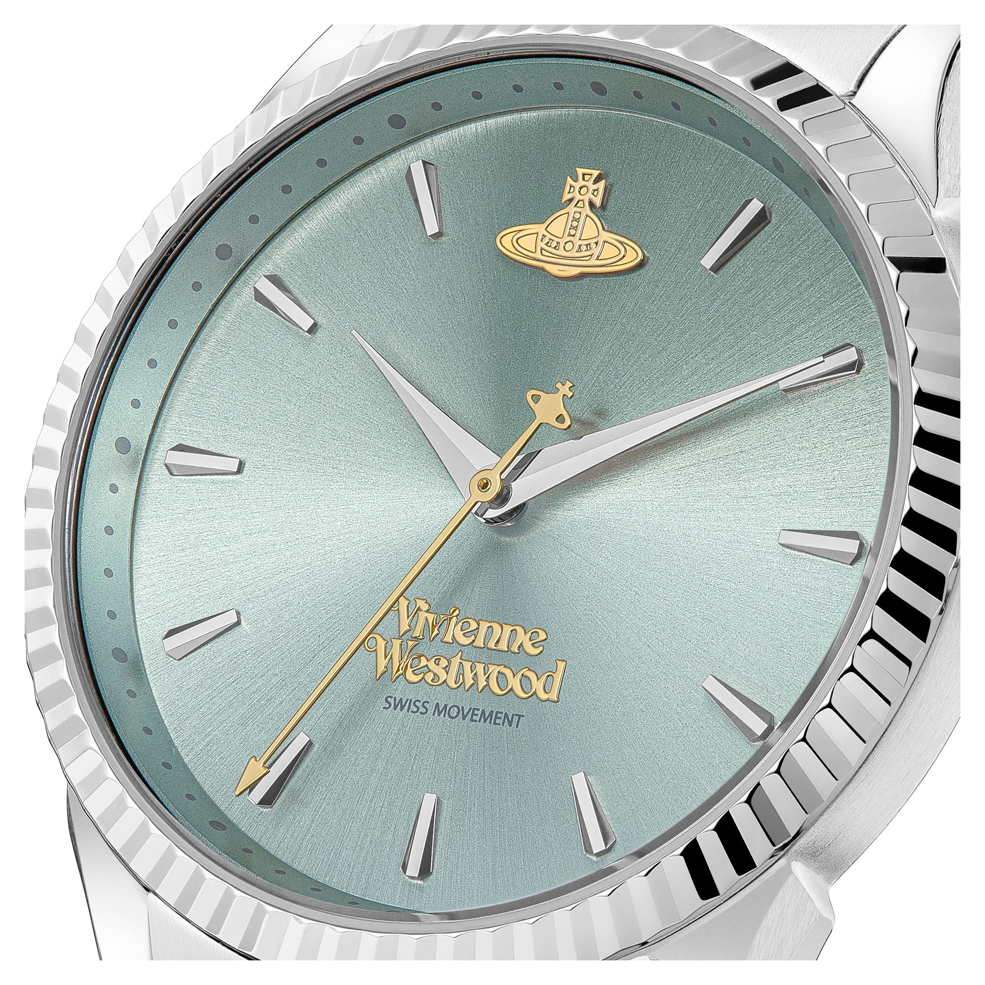 Close-up of Vivienne Westwood Orb Pop dial with pale green face, gold Orb, and gold hands