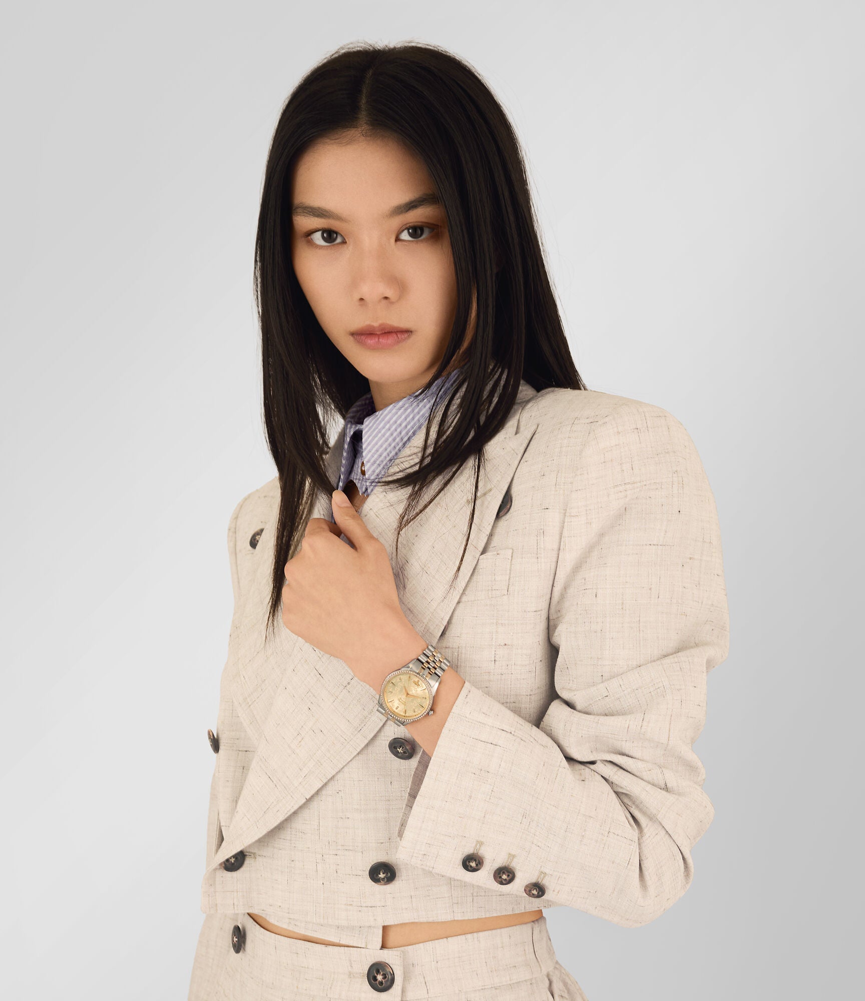 Woman wearing Vivienne Westwood VV208CPSG watch on wrist with two-tone bracelet