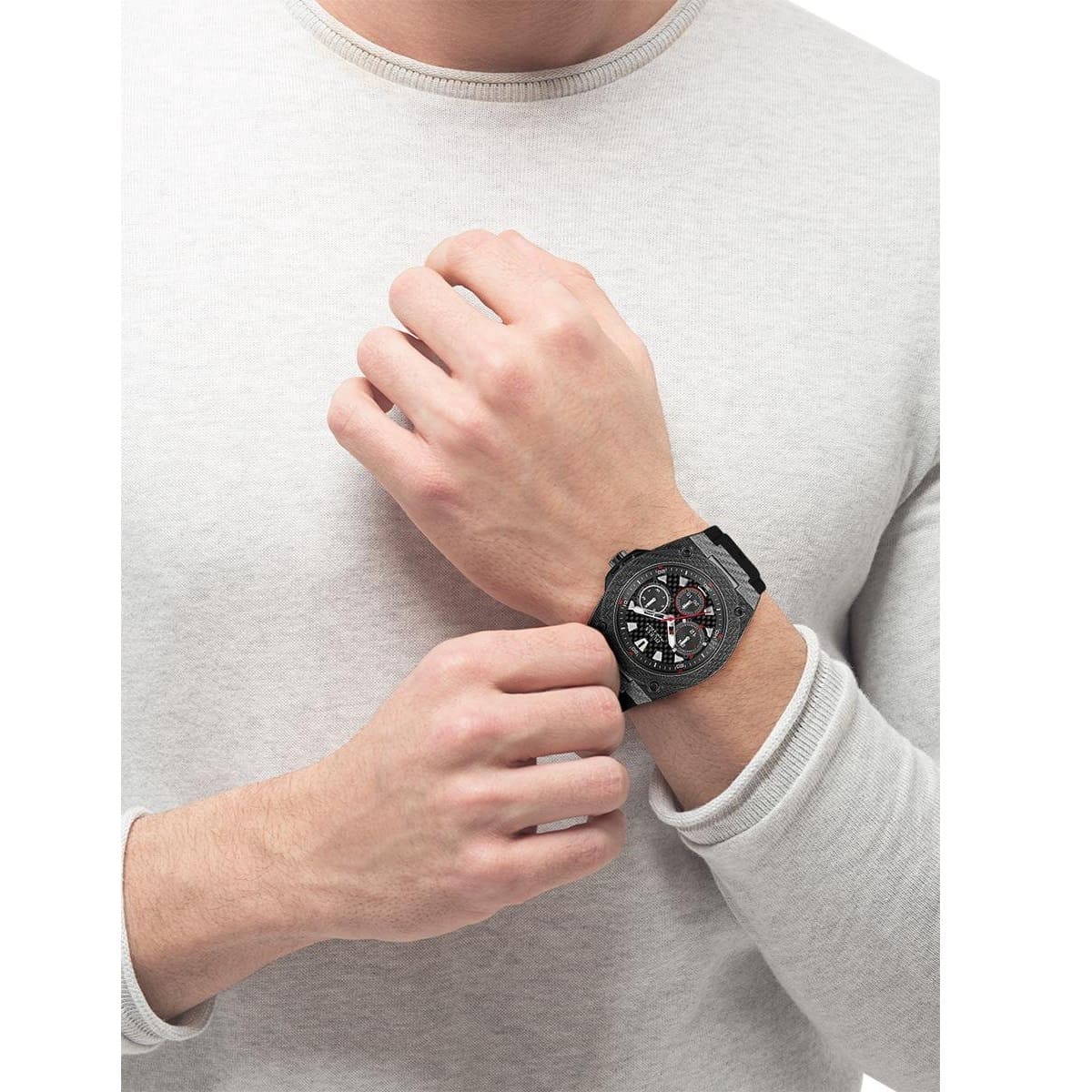 Guess Legacy watch on wrist over light-colored shirt