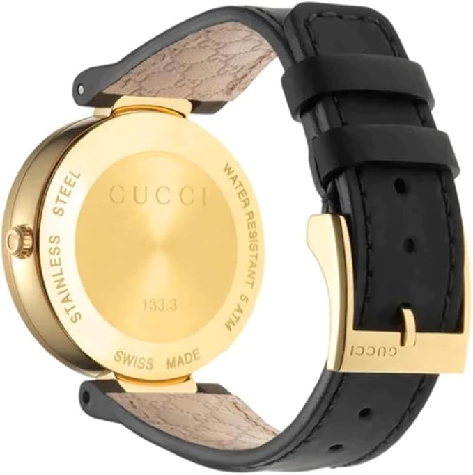 Gucci Grammy watch caseback showing gold-tone stainless steel engraving, Swiss Made marking, and model number 133.3
