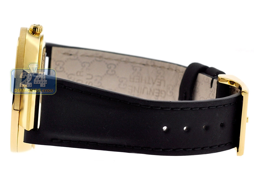 Gucci Interlocking G Grammy watch worn on wrist showing black leather strap and gold case with black dial